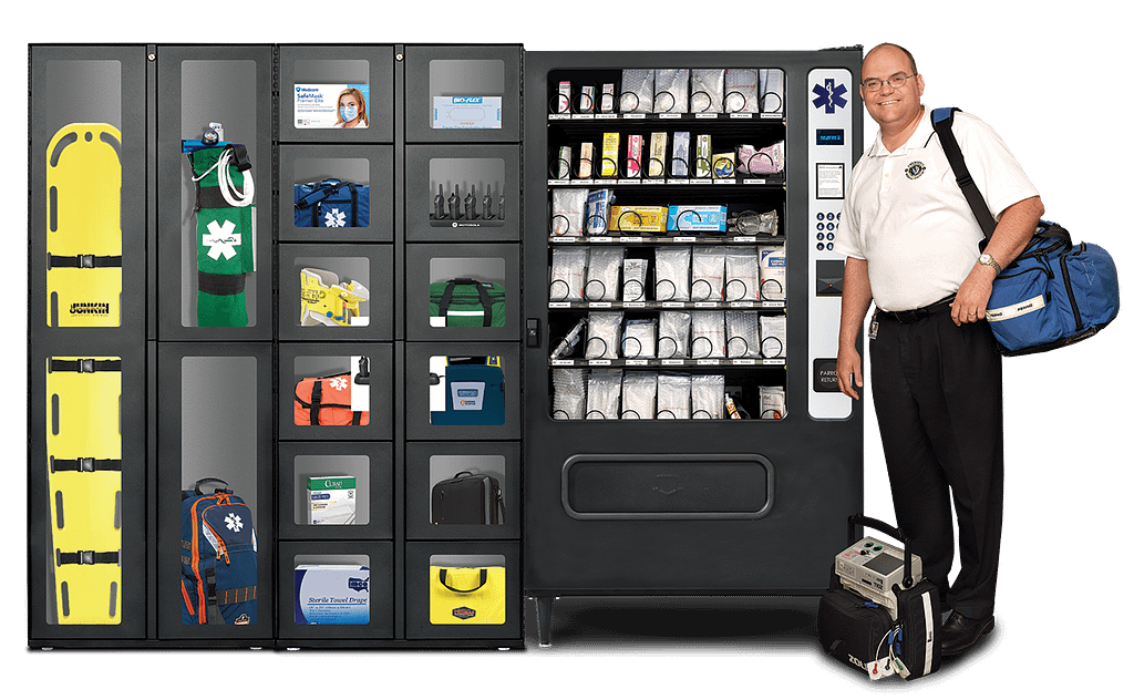 EMS professional standing next to bank of UCapIt EMS supply dispenser and two windowed supply lockers