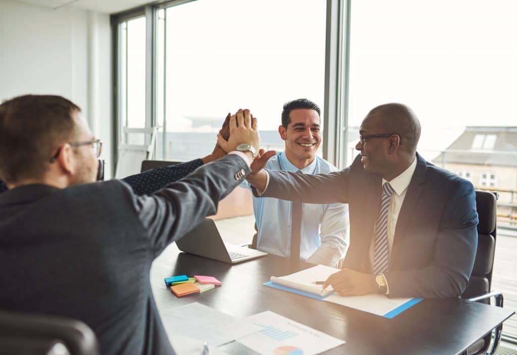 Business meeting with executives high-fiving