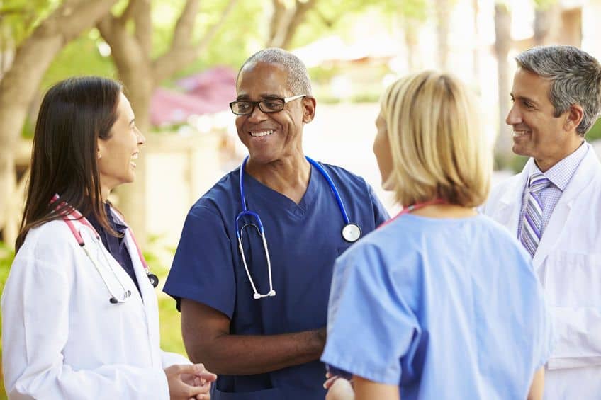 Image of healthcare professionals discussing medical topics in an outside setting