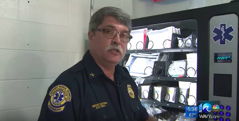 Image of paramedic in front of vending machine on local news