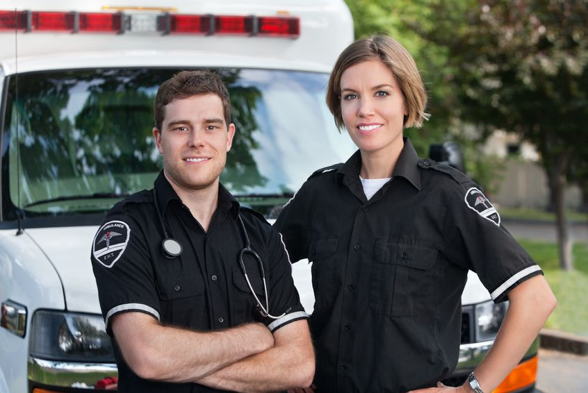 Image Male and Female EMT professionals in front of ambulance