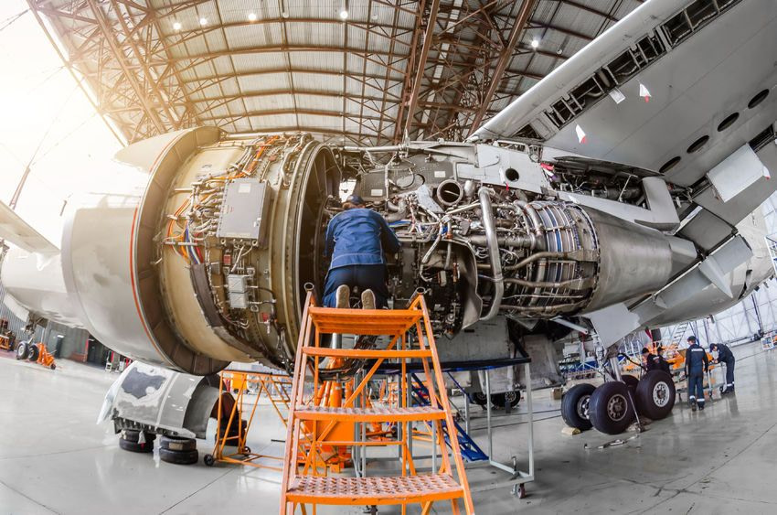 Aerospace engineers working on a plane engine