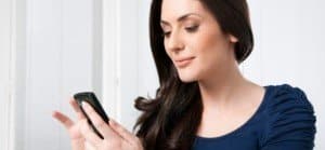 Image of woman smiling while browsing smartphone