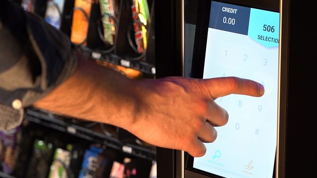 Man using the Evoke Snack 6 touch screen